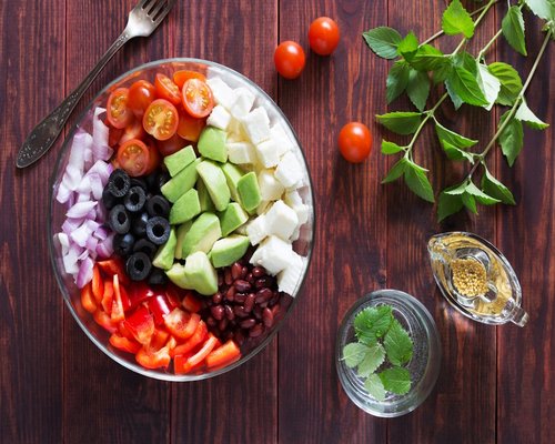 Healthy food flat lay with vegetables and fruits on wooden background